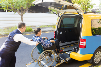 driver helping man on wheelchair